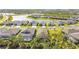 Aerial view of single-Gathering homes in a lakeside neighborhood, some with screened-in pools at 10735 Spring Tide Way, Parrish, FL 34219