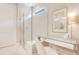 Bathroom featuring a glass-enclosed shower, vanity area, and bright natural light at 10735 Spring Tide Way, Parrish, FL 34219