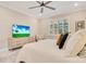 Bedroom featuring a bed, dresser with a tv and large window for natural light at 10735 Spring Tide Way, Parrish, FL 34219
