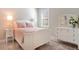 Charming bedroom with white furniture, light pink accents, and a bright window at 10735 Spring Tide Way, Parrish, FL 34219