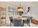 Cozy dining area with elegant lighting fixture, shutters, and stylish decor at 10735 Spring Tide Way, Parrish, FL 34219