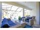 Beautiful patio with wicker furniture, blue cushions, and a view of the inviting pool area at 10735 Spring Tide Way, Parrish, FL 34219