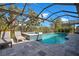Inviting screened-in pool with hot tub and lounge chairs, perfect for relaxing outdoors at 10735 Spring Tide Way, Parrish, FL 34219