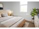 Modern bedroom with a bed, white walls, wood-look floors, and a large window at 3092 Crowder St, Port Charlotte, FL 33980