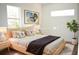 Bright bedroom with a wooden bed frame, soft linens, and neutral decor with modern art at 3092 Crowder St, Port Charlotte, FL 33980