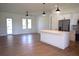 Open-concept living area with kitchen island and stainless steel appliances at 3092 Crowder St, Port Charlotte, FL 33980