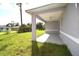 View of the covered patio and grassy backyard at 3092 Crowder St, Port Charlotte, FL 33980