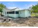Backyard view of the house with a screened-in porch and minimalist landscaping at 514 Fitzhugh Ave, Punta Gorda, FL 33950