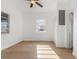 Bedroom with window and ceiling fan with white paint and wood-look flooring at 514 Fitzhugh Ave, Punta Gorda, FL 33950