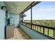 A balcony with a ceiling fan, overlooking a neighborhood with mature landscaping at 14810 Rue De Bayonne # 7B, Clearwater, FL 33762