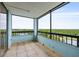 A covered balcony that offers expansive views of lush greenery and a tranquil lake at 14810 Rue De Bayonne # 7B, Clearwater, FL 33762
