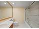 Bathroom with a tub-shower combo featuring glass doors and white tile at 14810 Rue De Bayonne # 7B, Clearwater, FL 33762