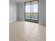Tile flooring leads to a sliding door providing views from the interior of this light filled bedroom at 14810 Rue De Bayonne # 7B, Clearwater, FL 33762