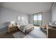An airy bedroom with a sliding glass door and neutral décor, providing a serene retreat at 14810 Rue De Bayonne # 7B, Clearwater, FL 33762