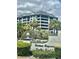 Chateau Bayonne condominium complex entrance with manicured landscaping at 14810 Rue De Bayonne # 7B, Clearwater, FL 33762