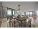 Light-filled dining and living space features a modern table, chairs, rug, couch, and views from the balcony at 14810 Rue De Bayonne # 7B, Clearwater, FL 33762