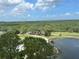 Scenic golf course view with lush greenery, serene lake, blue sky, and distant ocean at 14810 Rue De Bayonne # 7B, Clearwater, FL 33762