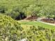 Scenic golf course with players visible on the green, surrounded by lush trees at 14810 Rue De Bayonne # 7B, Clearwater, FL 33762