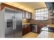 A kitchen featuring granite countertops, stainless steel appliances, and dark wood cabinetry at 14810 Rue De Bayonne # 7B, Clearwater, FL 33762