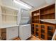 Laundry room with washer, dryer, storage cabinets and shelving at 14810 Rue De Bayonne # 7B, Clearwater, FL 33762