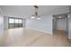 Empty room with neutral tile flooring, sliding glass door access to balcony, and an overhead light fixture at 14810 Rue De Bayonne # 7B, Clearwater, FL 33762