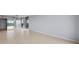 Neutral empty room with tile flooring and sliding glass doors leading to a balcony, perfect for customization at 14810 Rue De Bayonne # 7B, Clearwater, FL 33762