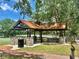 A shaded picnic shelter with tables and benches, set in a park-like setting at 14810 Rue De Bayonne # 7B, Clearwater, FL 33762