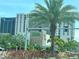 Street view of modern apartment buildings, a Publix store, and palm trees at 14810 Rue De Bayonne # 7B, Clearwater, FL 33762