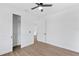 Bright bedroom with ceiling fan, view to closet, and wood-look flooring at 2805 Anniston Rd, North Port, FL 34288