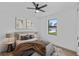 Stylized bedroom with neutral tones, ceiling fan and natural light from a window at 2805 Anniston Rd, North Port, FL 34288