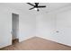 Bright bedroom with ceiling fan, view to closet, and wood-look flooring at 2805 Anniston Rd, North Port, FL 34288