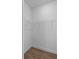 Walk-in closet with white walls, wood-look flooring, and white wire shelving at 2805 Anniston Rd, North Port, FL 34288