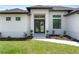 Close up of the front door with decorative landscaping and a stone paver walkway at 2805 Anniston Rd, North Port, FL 34288