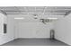 Clean two-car garage with painted floor, storage, and modern lighting at 2805 Anniston Rd, North Port, FL 34288