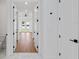 Hallway showing transition from tile to wood floors at 2805 Anniston Rd, North Port, FL 34288