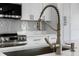 Close up of the kitchen faucet and sink, stainless steel appliances at 2805 Anniston Rd, North Port, FL 34288