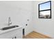 Laundry room with sink, quartz countertop, window and wire shelf at 2805 Anniston Rd, North Port, FL 34288
