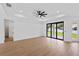 Large living room with a modern ceiling fan and sliding glass doors to the outside at 2805 Anniston Rd, North Port, FL 34288