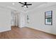 Bright main bedroom with wood floors, ceiling fan, and ensuite bath at 2805 Anniston Rd, North Port, FL 34288