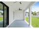 Covered patio with ceiling fan, and view of the backyard at 2805 Anniston Rd, North Port, FL 34288