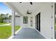 Covered outdoor patio with ceiling fan, white columns, and sliding glass door at 2805 Anniston Rd, North Port, FL 34288