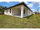 Back patio with view of a lush green lawn at 1080 Dunlap Ave, Spring Hill, FL 34609