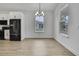 Dining area with a modern chandelier and a view of the backyard at 1080 Dunlap Ave, Spring Hill, FL 34609