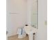 Simple powder room with pedestal sink and mirror, offering functionality and convenience at 235 Cocoanut Ave # 129E, Sarasota, FL 34236