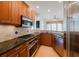 Updated kitchen features wood cabinets, granite countertops, and stainless steel appliances at 235 Cocoanut Ave # 129E, Sarasota, FL 34236