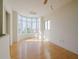 Bright living room with hardwood floors, high ceilings, and a large bay window at 235 Cocoanut Ave # 129E, Sarasota, FL 34236
