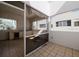 Outdoor patio with tiled floor, fire pit, kitchenette, and partial screens at 235 Cocoanut Ave # 129E, Sarasota, FL 34236