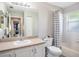Bathroom featuring a shower-tub combo and a vanity with a sink and a large mirror at 4601 Copper Ln, Plant City, FL 33566