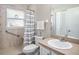 Bright bathroom featuring a shower with grab bars and a vanity with a sink and a mirror at 4601 Copper Ln, Plant City, FL 33566