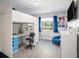 Well-lit bedroom featuring a modern loft bed with a desk underneath and blue accents at 4601 Copper Ln, Plant City, FL 33566